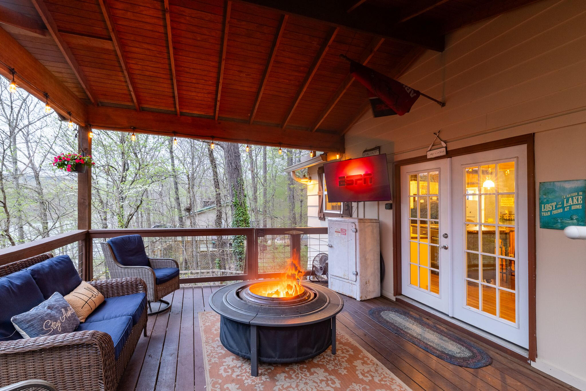 Fireside Game Night or Movie Time Watch the big game or stream your favorite shows from the deck—right next to the firepit, under string lights, and surrounded by trees.